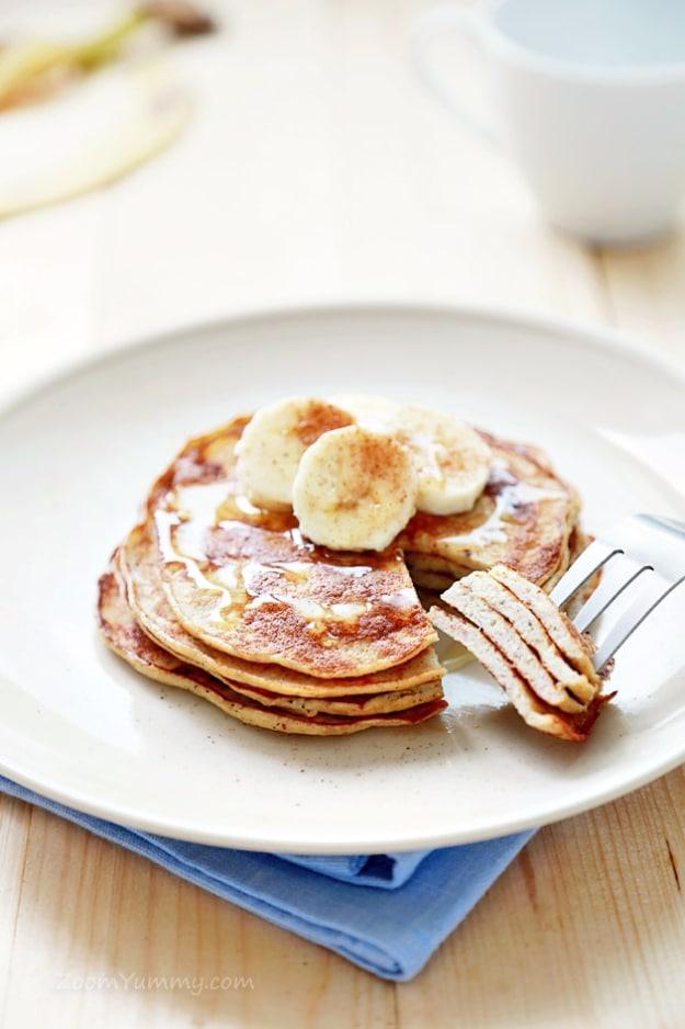A stack of three ingredient banana pancakes topped with sliced banana, a fast breakfast with few ingredients