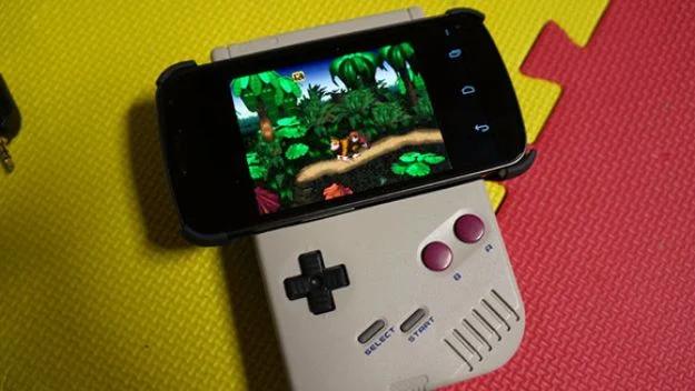 Original gray Game Boy shell with an Android phone mounted above the screen, playing a retro game in color