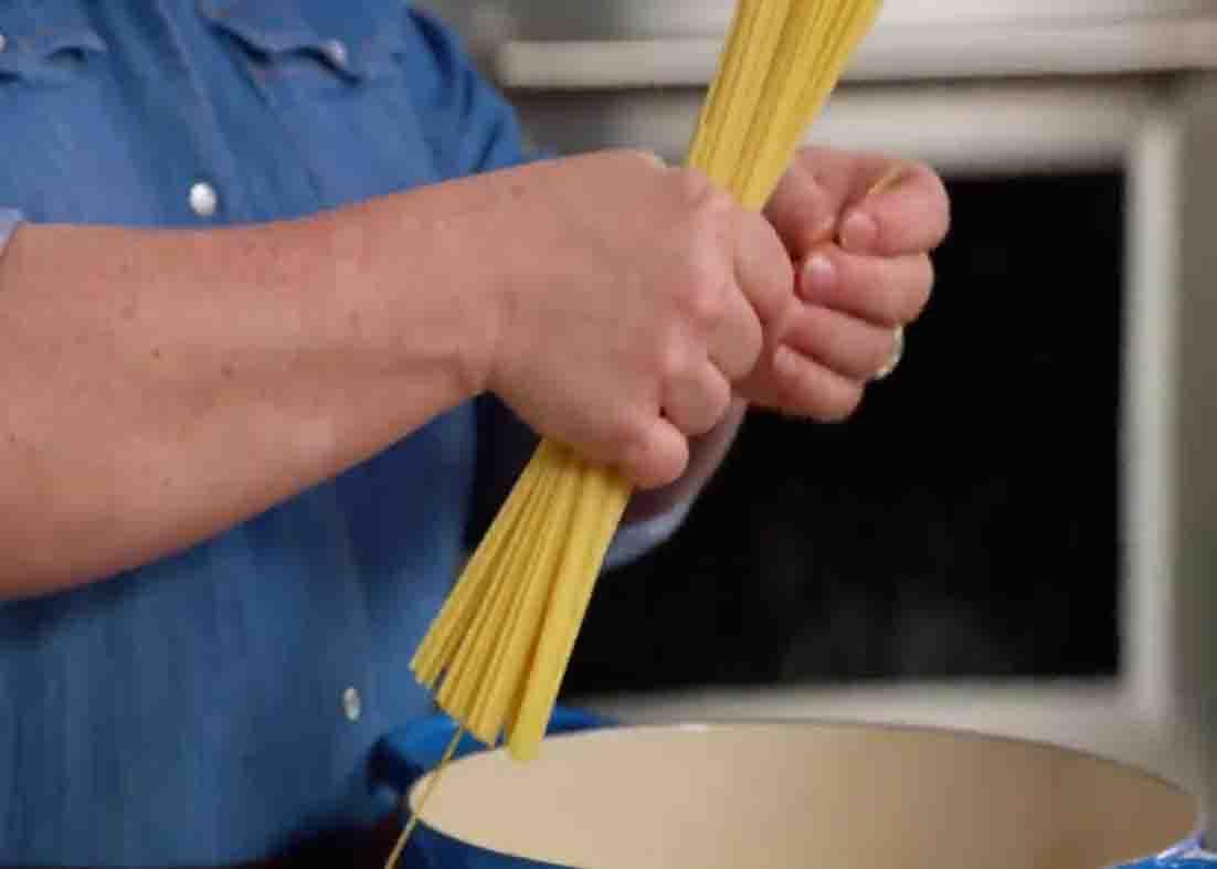Adding the pasta to the chicken noodle soup