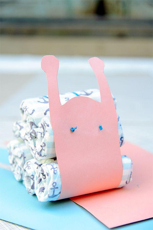 DIY baby shower decoration diaper snail with a pink card stock shell wrapped around rolled anchor print diapers