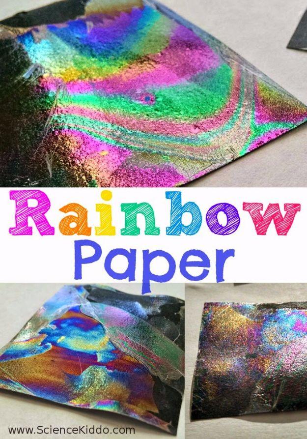Rainbow paper, squares of black paper sheened with green pink and gold oil slick colors from a thin film of clear nail polish