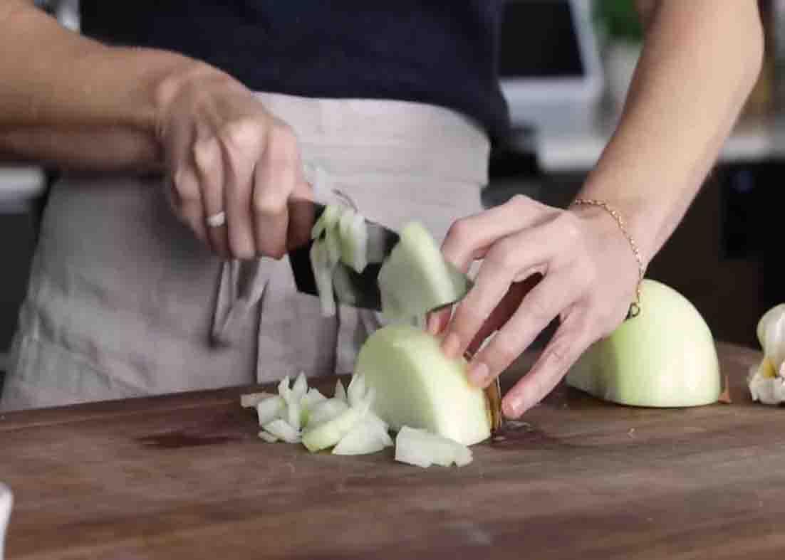 Chopping the onion for the turmeric chicken and rice casserole