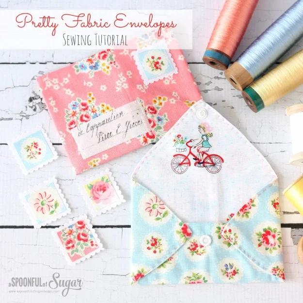 Small fabric envelopes in floral prints, each closed with a wooden button and elastic loop, sewn from fabric scraps