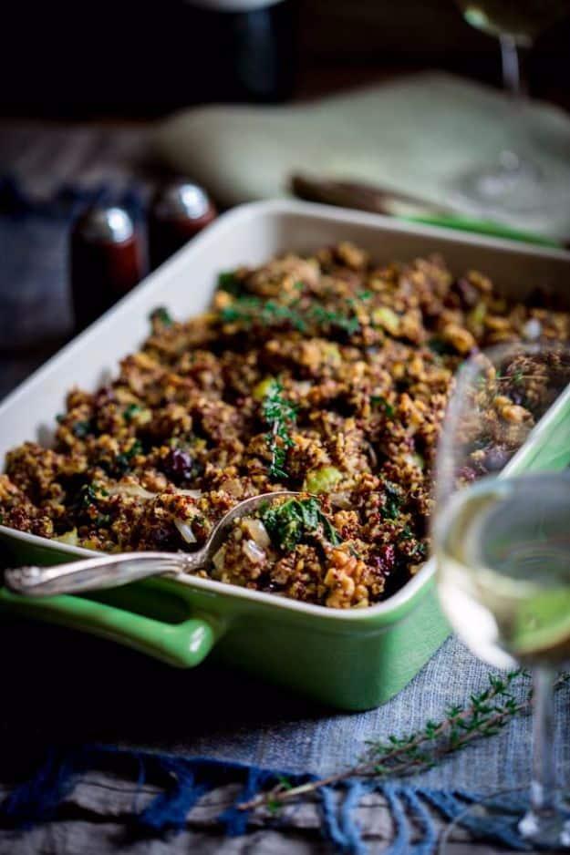 Gluten free quinoa stuffing with chopped kale, toasted walnuts and dried cranberries in a baking dish