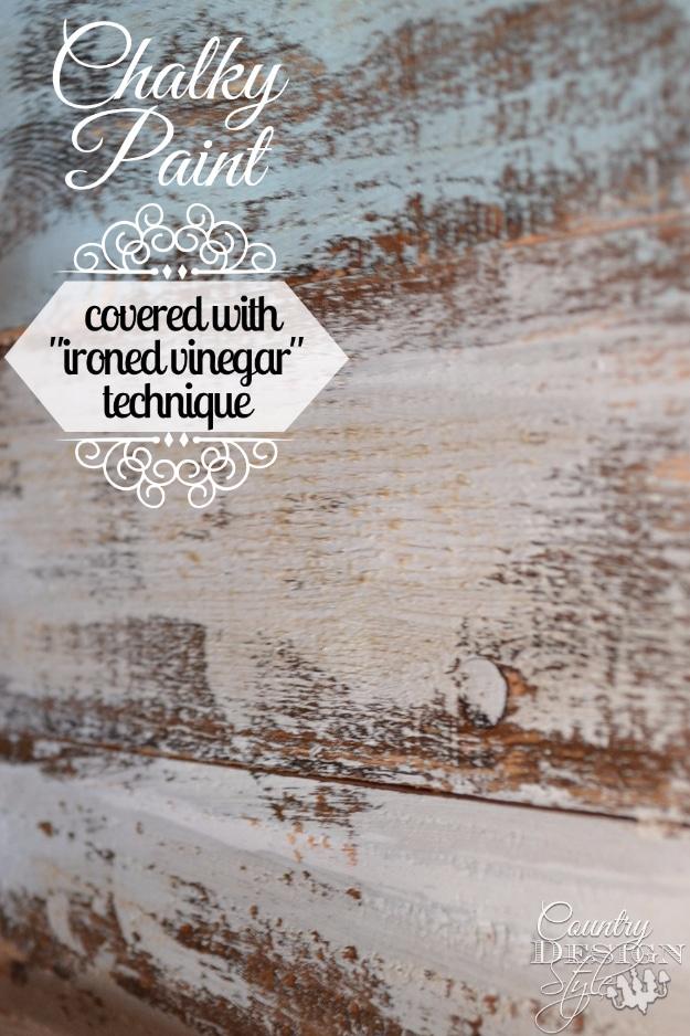 Chalky paint over ironed vinegar aged wood, pale blue gray and rust brown weathered boards in a DIY paint technique