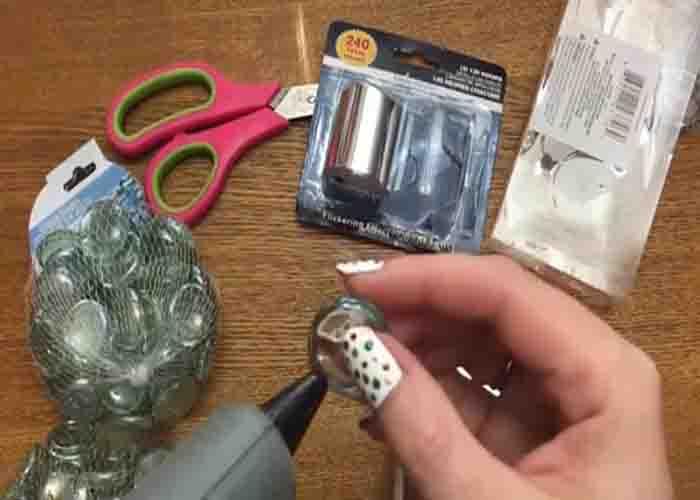 Attaching the glass gems to the mirror to make the tea light candle holder