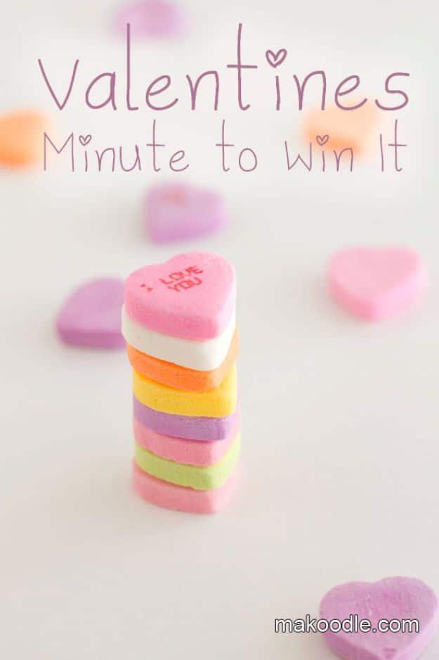 Valentines minute to win it game with kids stacking conversation hearts into a tower against a timer