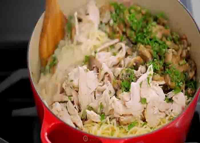 Mixing the chicken tetrazzini into the pot