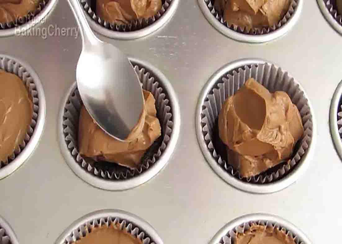 Topping the brownie base with the cheesecake mixture