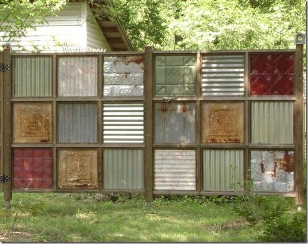 Cool recycled metal DIY fence, a patchwork panel of salvaged corrugated and pressed tin sheets in a wooden grid frame