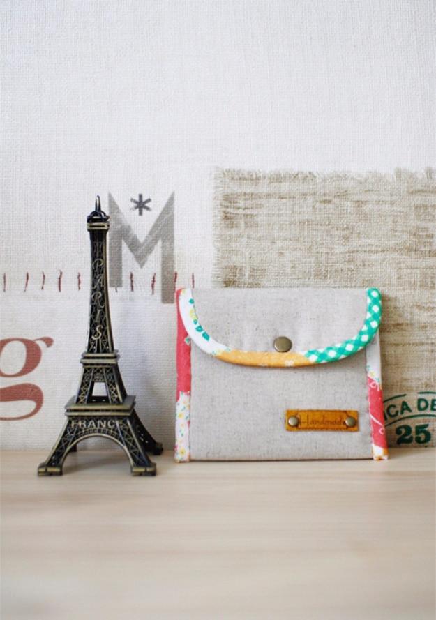 Easy padded coin purse, a small quilted floral purse with an aqua polka dot flap and snap beside an Eiffel Tower figurine
