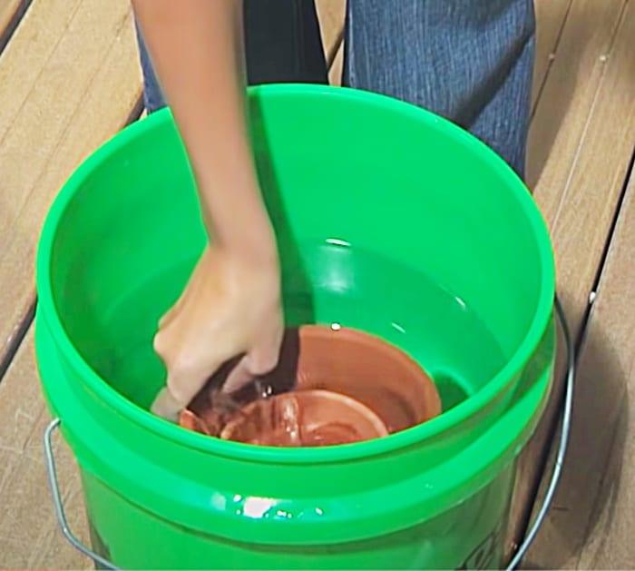Soak terracotta pots to drill holes for a fountain