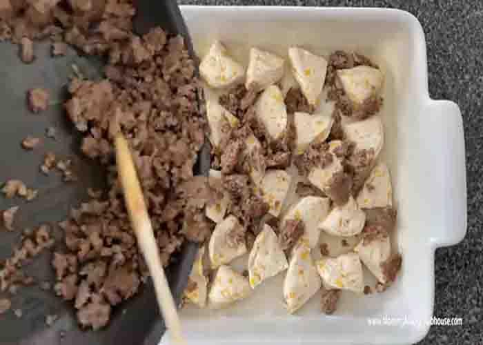 Assembling the biscuits and gravy casserole