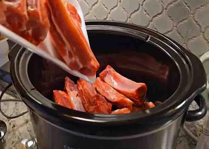 Adding the pork ribs to the slow cooker