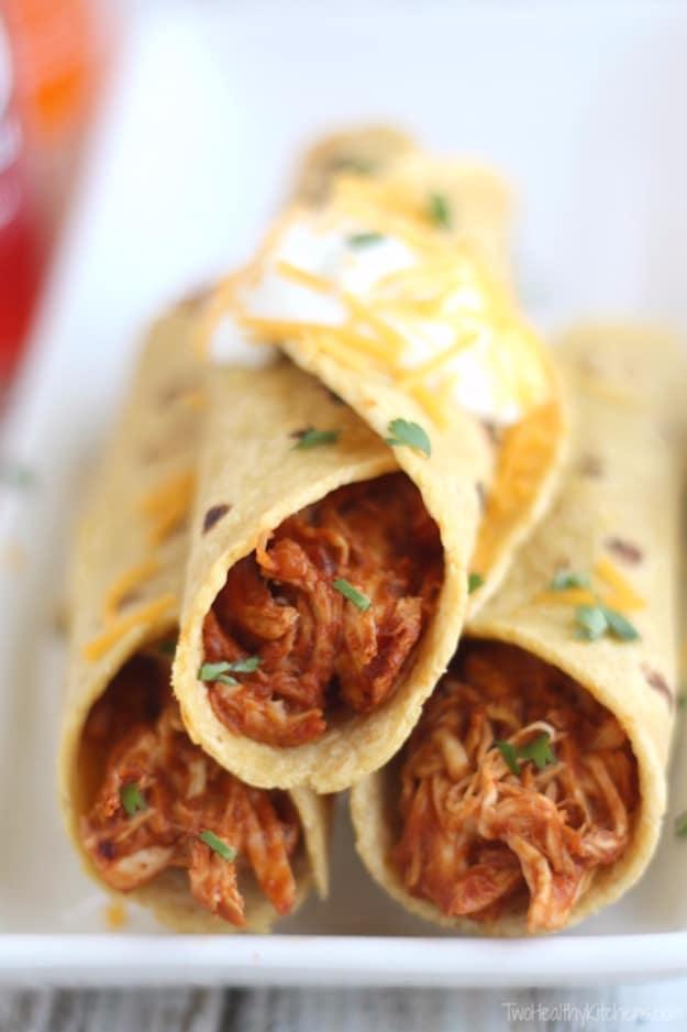 Crock pot chicken tacos in soft tortillas with cheese, a 3 ingredient dinner made in the slow cooker