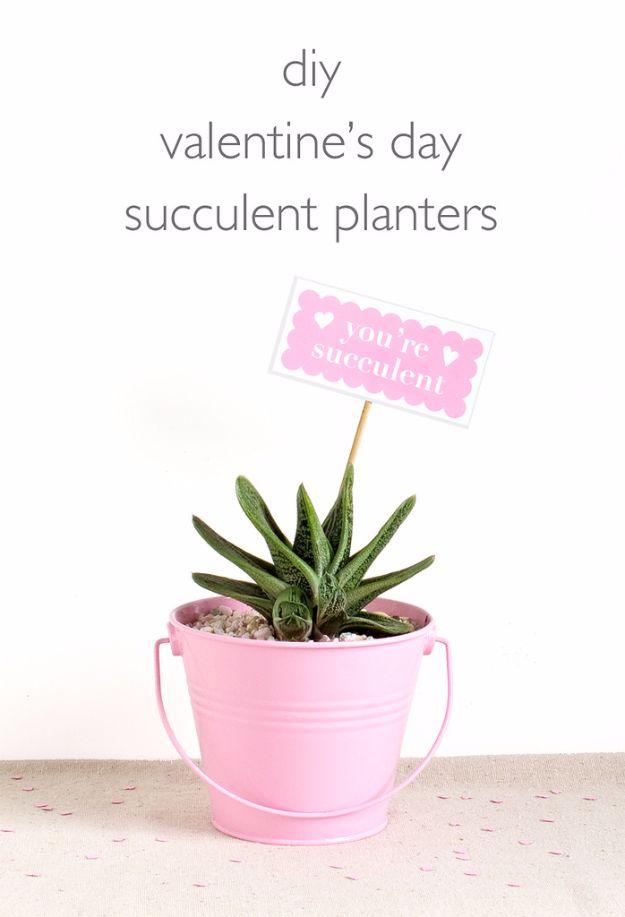 A small painted bucket planted with a succulent and tied with a gift tag, an easy DIY Valentine gift for her