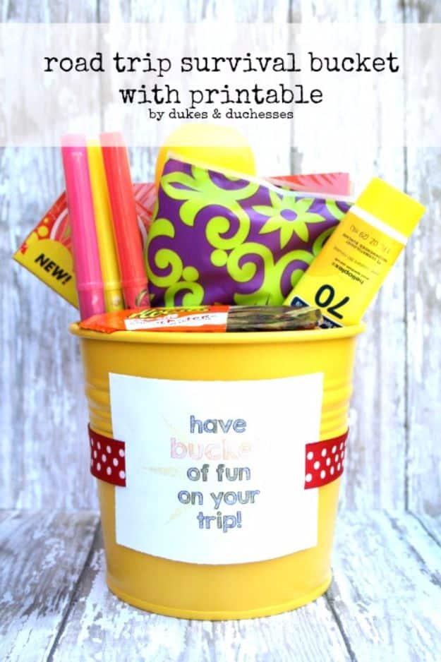 Road trip survival bucket, a yellow metal pail filled with glow sticks, markers and sunscreen with a printable label