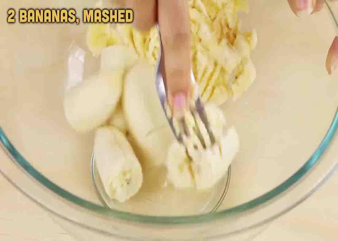 Mashing the overripe bananas for the berry egg muffins recipe