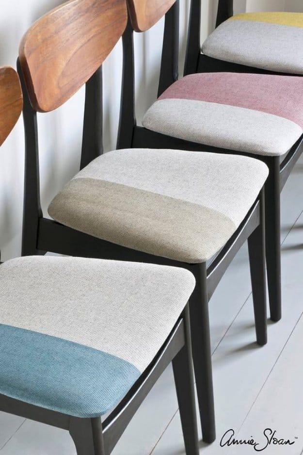 Set of mid century chairs with black frames, bare wood backs and seat pads dyed in pink, cream and blue blocks