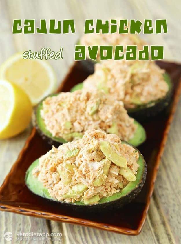 Cajun chicken stuffed avocado halves filled with seasoned chicken salad under a large recipe title graphic