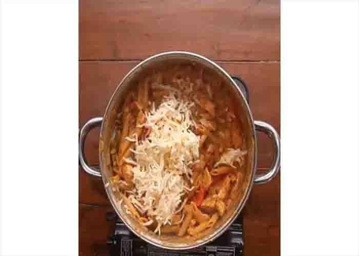 Adding the cheese to the chicken fajita pasta