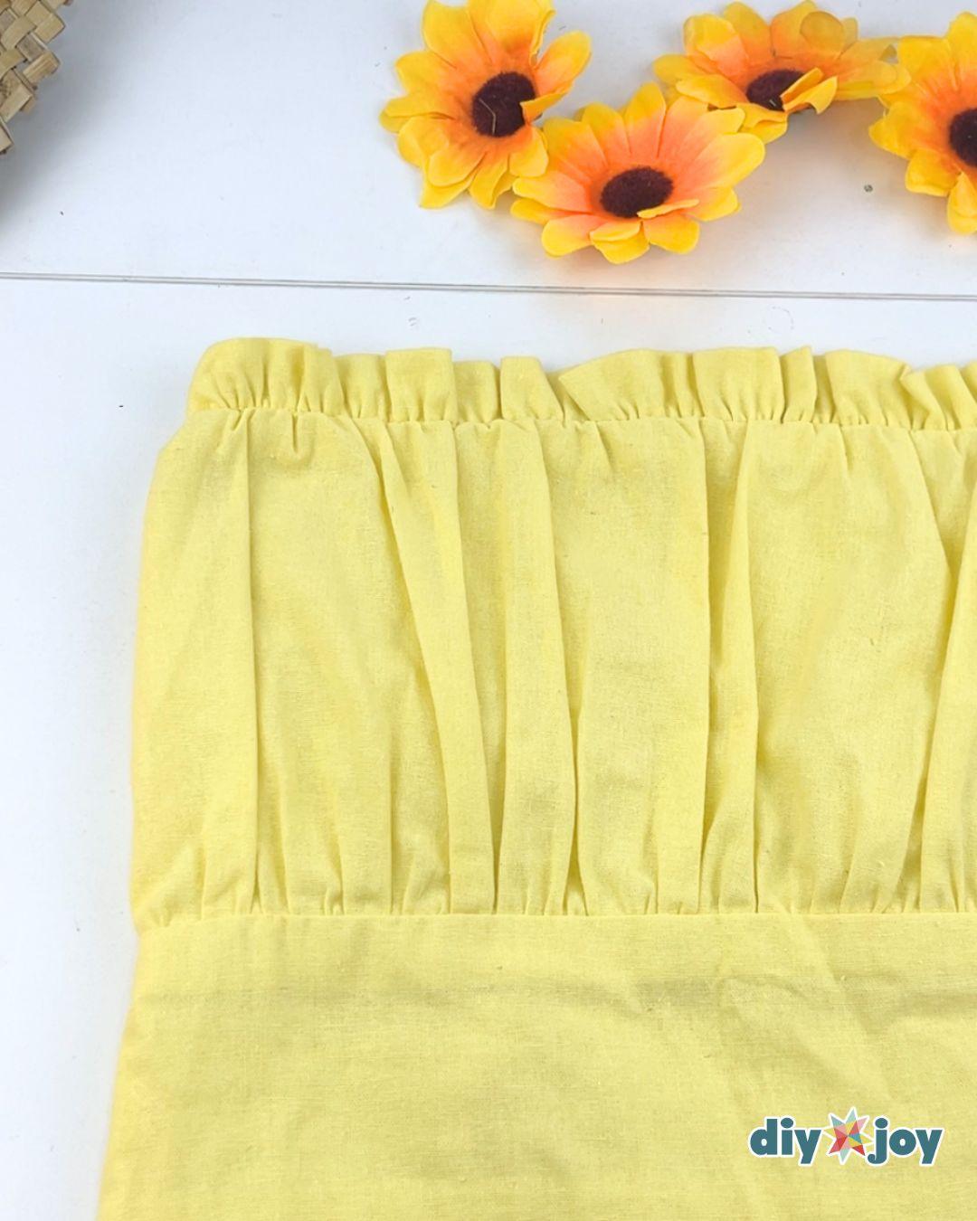 Homemade Couples Costume Sunflower And Gardener - yellow dress laid flat before the sunflowers are glued on.