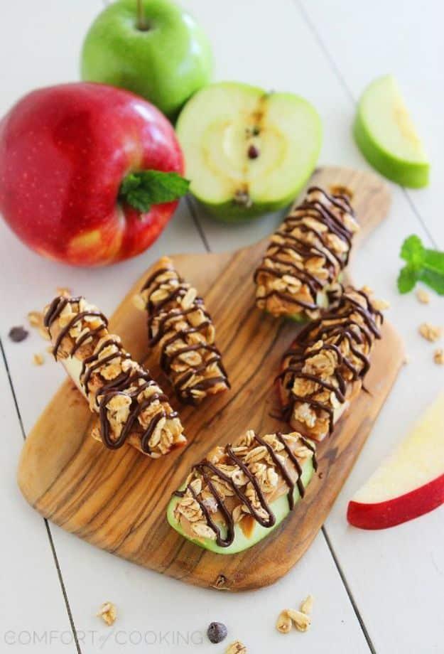 Chocolate peanut butter granola apple bites on apple rounds with a dark chocolate drizzle, a five minute after school snack