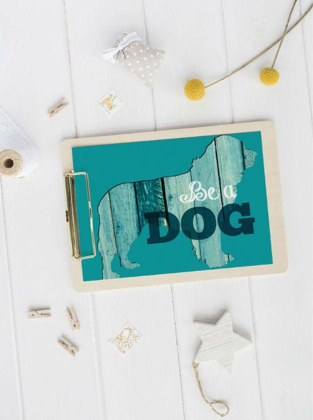 Be a dog free printable, a dog silhouette filled with weathered teal wood grain and black lettering, clipped to a pale wood