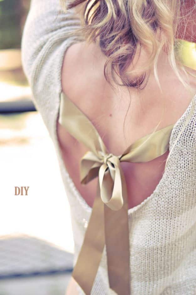 DIY clothes for winter, the back of a cream knit sweater with a cut out opening closed by a gold satin ribbon bow
