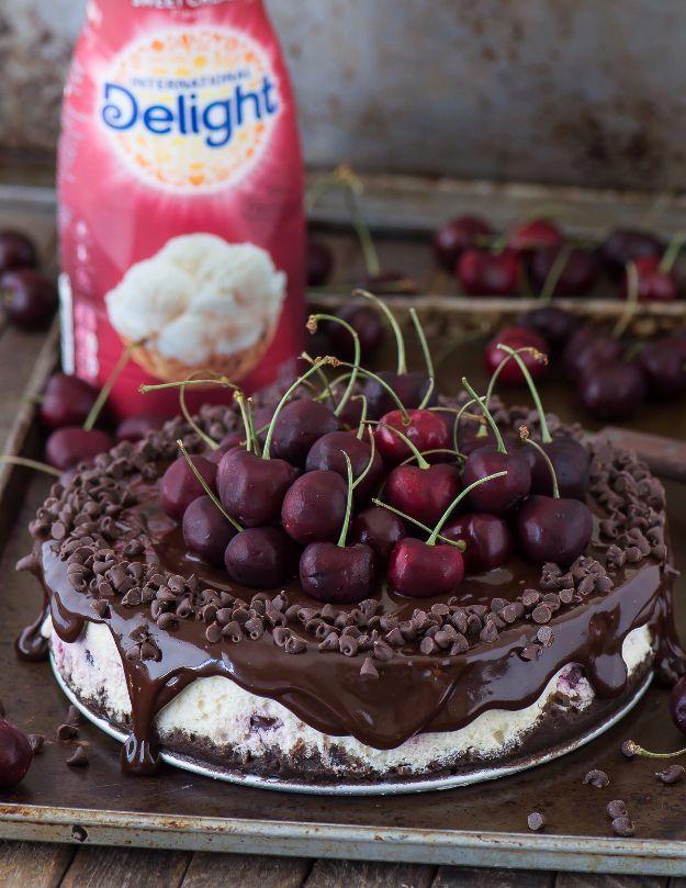 Chocolate cherry cheesecake under dark ganache piled with whole cherries, an International Delight creamer behind