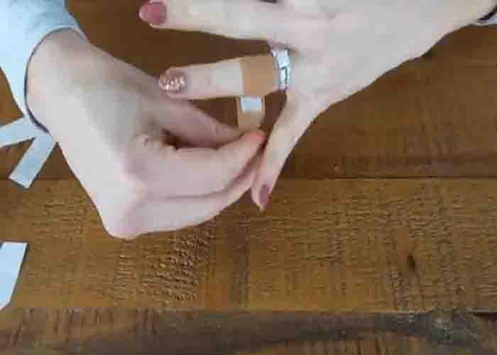 Using band aid to remove stuck ring on your finger