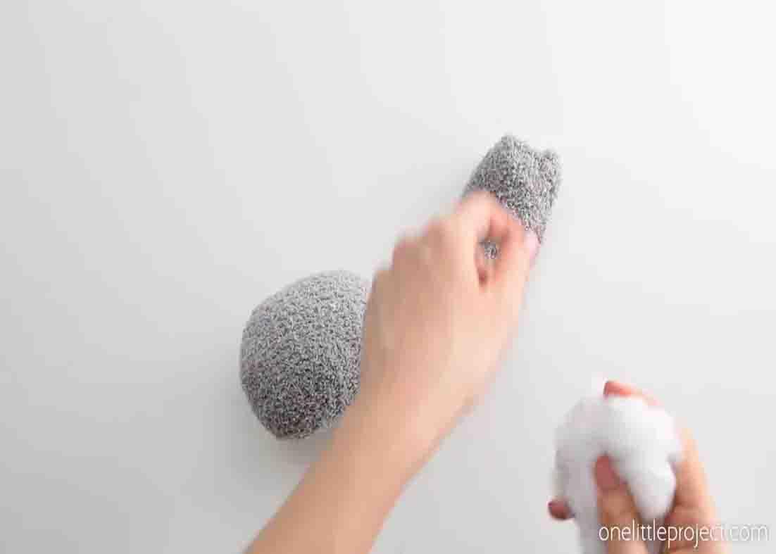 Stuffing the socks with some teddy bear stuffing