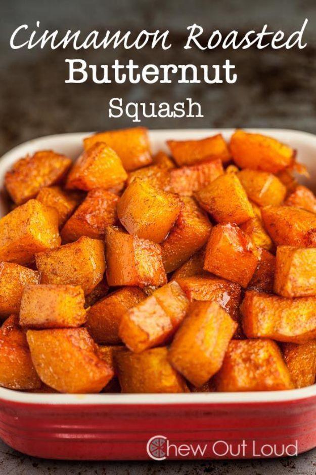 Cinnamon roasted butternut squash cubes piled in a red baking dish with caramelized golden brown edges