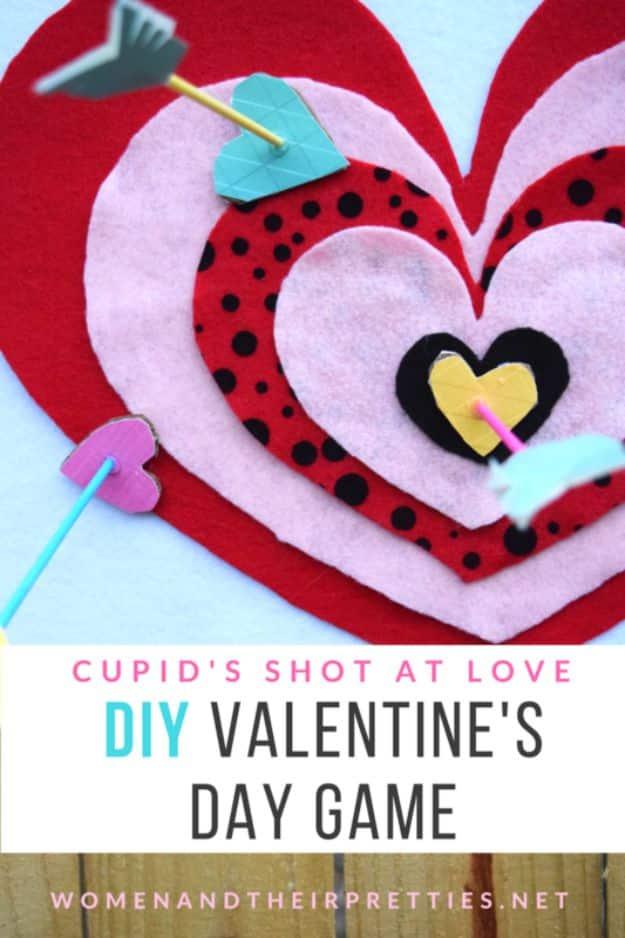 Cupid's Shot At Love Valentine game, a felt covered cardboard heart dartboard in pink and red on a wall