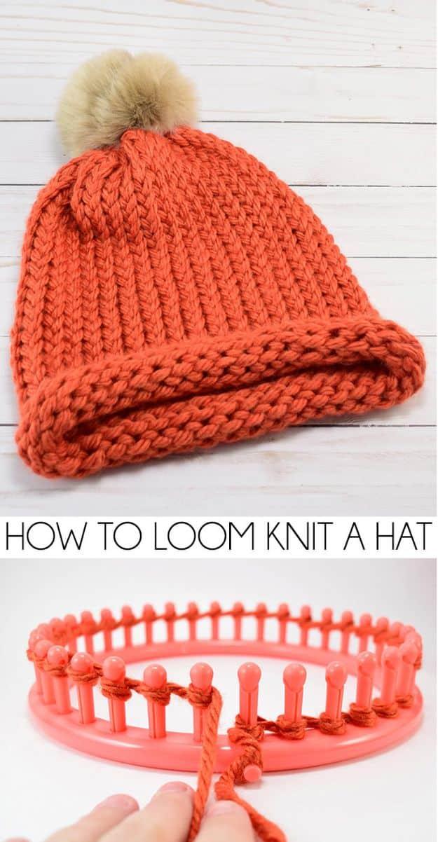 Orange loom knit bobble hat with a fur pompom above a coral round knitting loom with yarn wrapped on the pegs