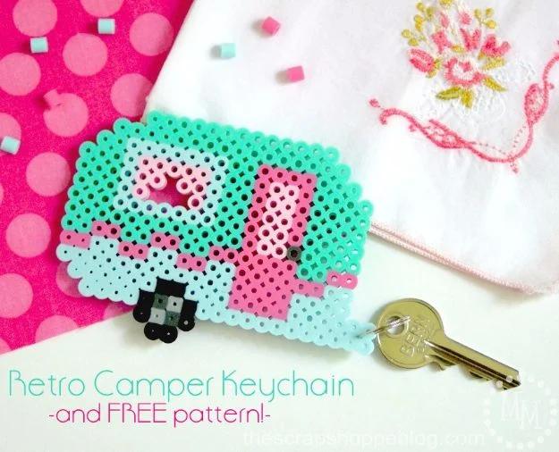 Perler bead keychain shaped like a retro turquoise camper trailer, a fun travel themed bead craft idea