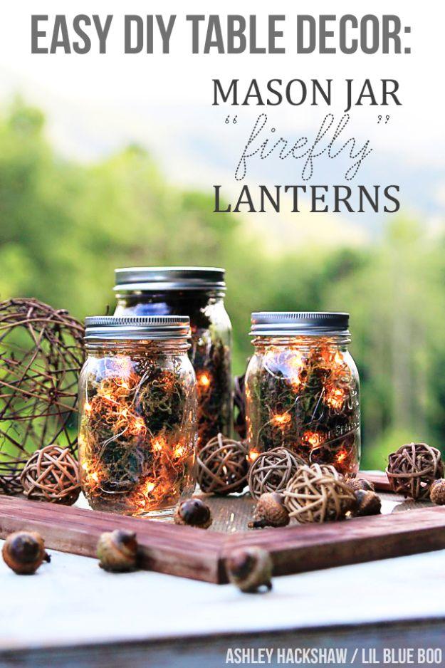 Pin graphic reading Easy DIY Table Decor Mason Jar Firefly Lanterns showing lit jars of moss and twig balls