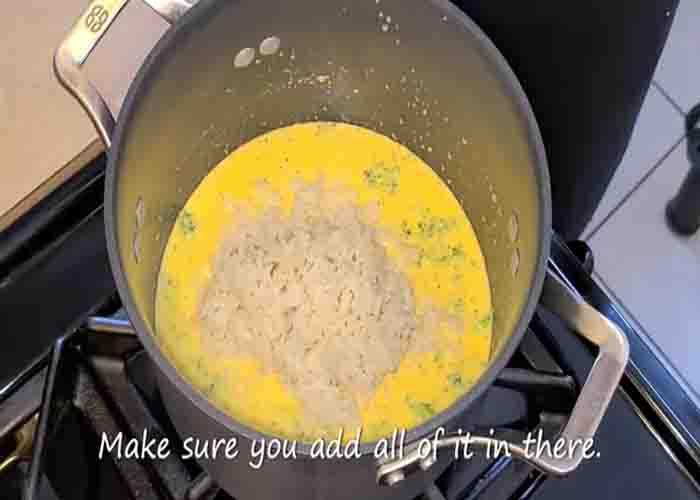 Mixing the broccoli, cheese, and rice