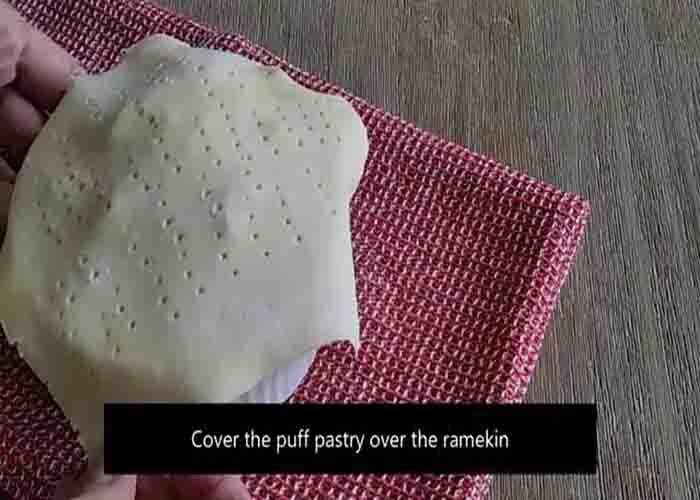 Covering the tuna pot pie with a sheet of puff pastry