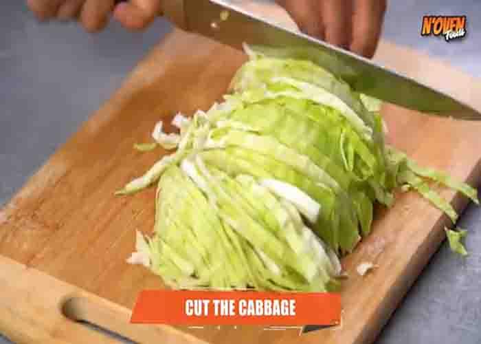Shredding the cabbage for the omelet recipe