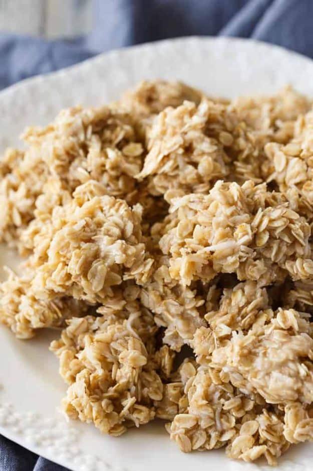 Fiddle diddles, pale golden oat and coconut no bake cookies piled up high on a plain white serving plate