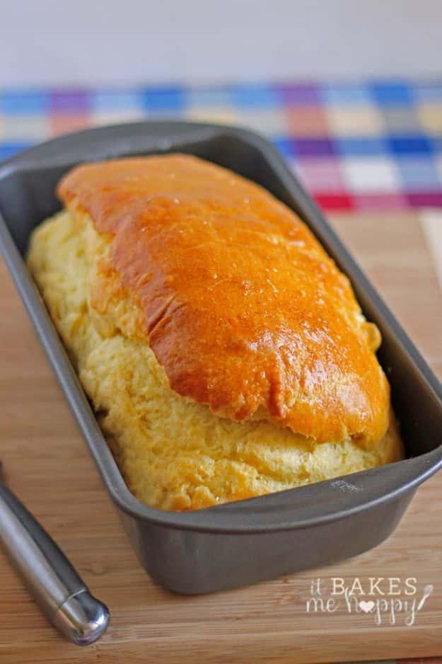French brioche loaf with a deep golden egg washed crust, sliced to show the rich yellow buttery crumb