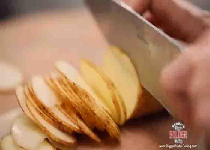 Cutting the potatoes into thin slices