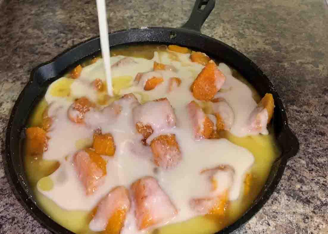Adding the batter to the sweet potato mixture before baking it