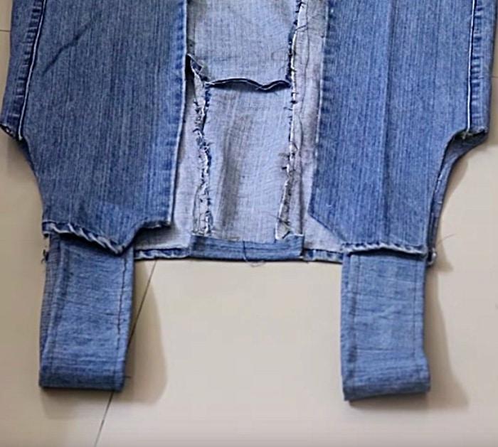 Make a long denim woman's vest out of a large pair of men's jeans