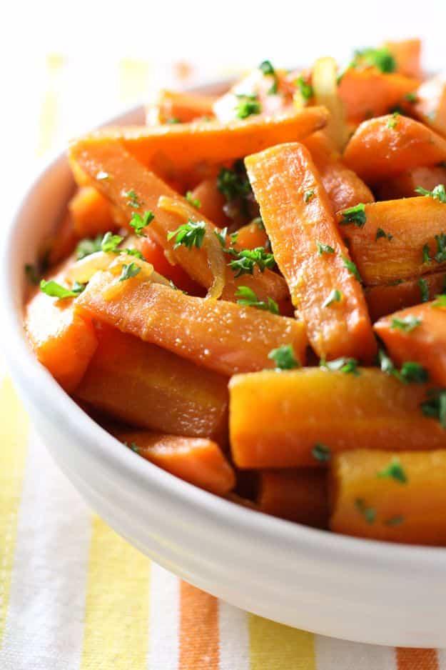 Roasted carrot sticks with ground coriander and maple, topped with caramelized onions and chopped parsley