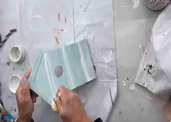 Painting the birdhouse blue and white