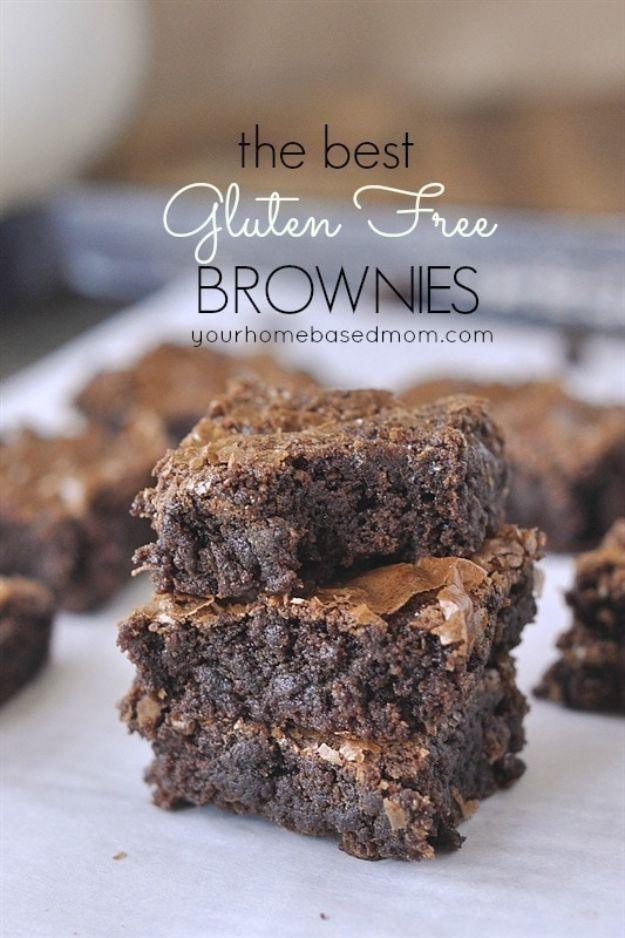 Gluten free brownies cut into squares showing a dense fudgy center and a crackly top, on parchment paper