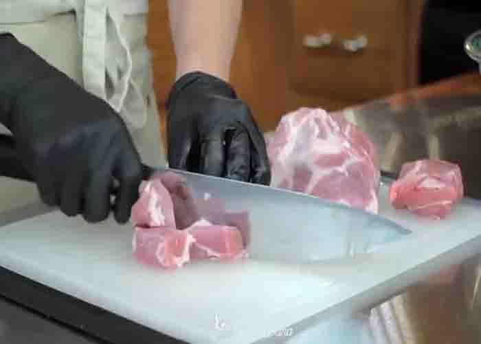 Cutting the pork for the chile Colorado recipe