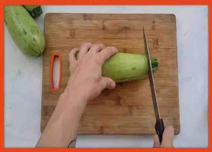 Slicing the zucchini into halves for the zucchini boats recipe
